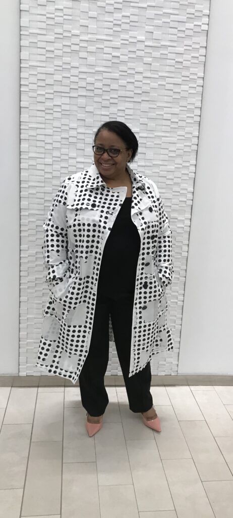 Lorrie standing wearing a black and white Akris Punto jacket