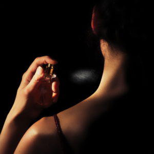 woman spraying fragrance